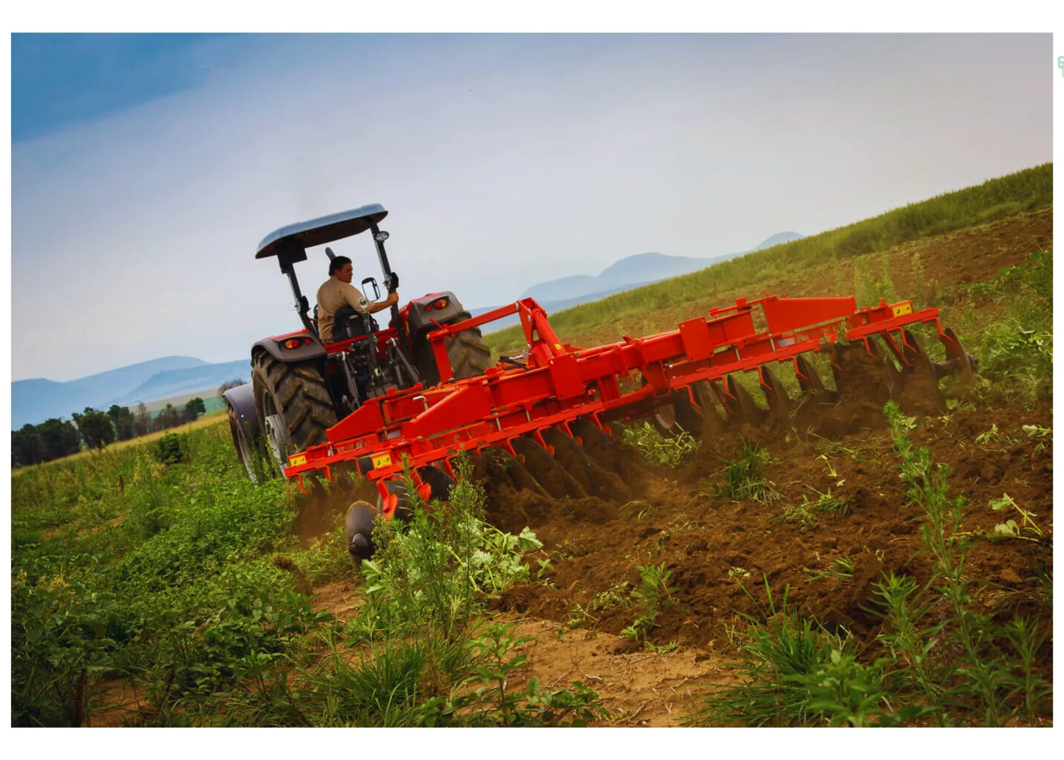 Disc harrow working behind a tractor in the field